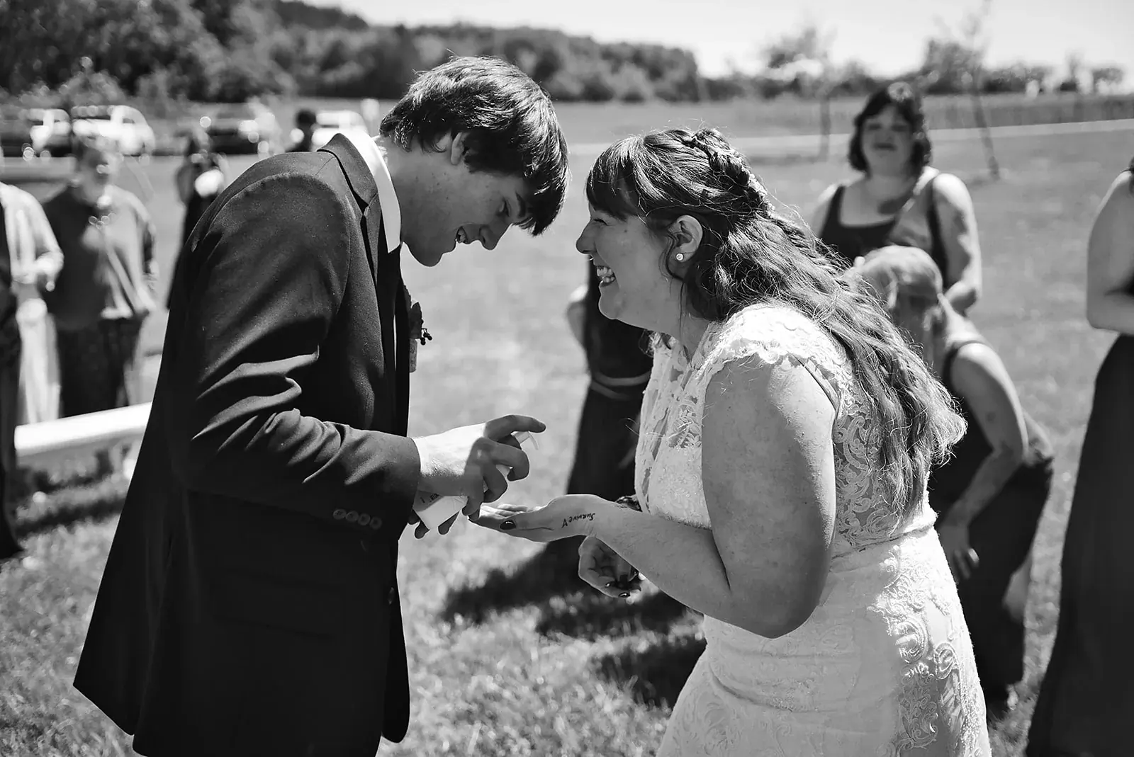 Ring exchange in black and white — Kayla & Robert's wedding at Mackinaw Trail Winery, Petoskey