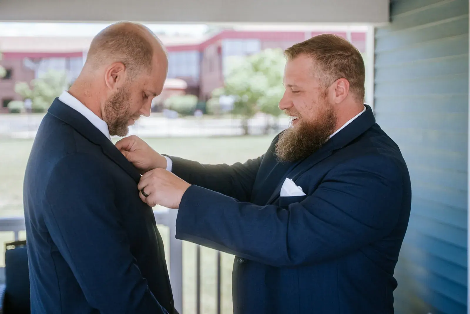 Best man pinning boutonniere — Kelly & Ezra's wedding at Aria at The Whitcomb, St. Joseph