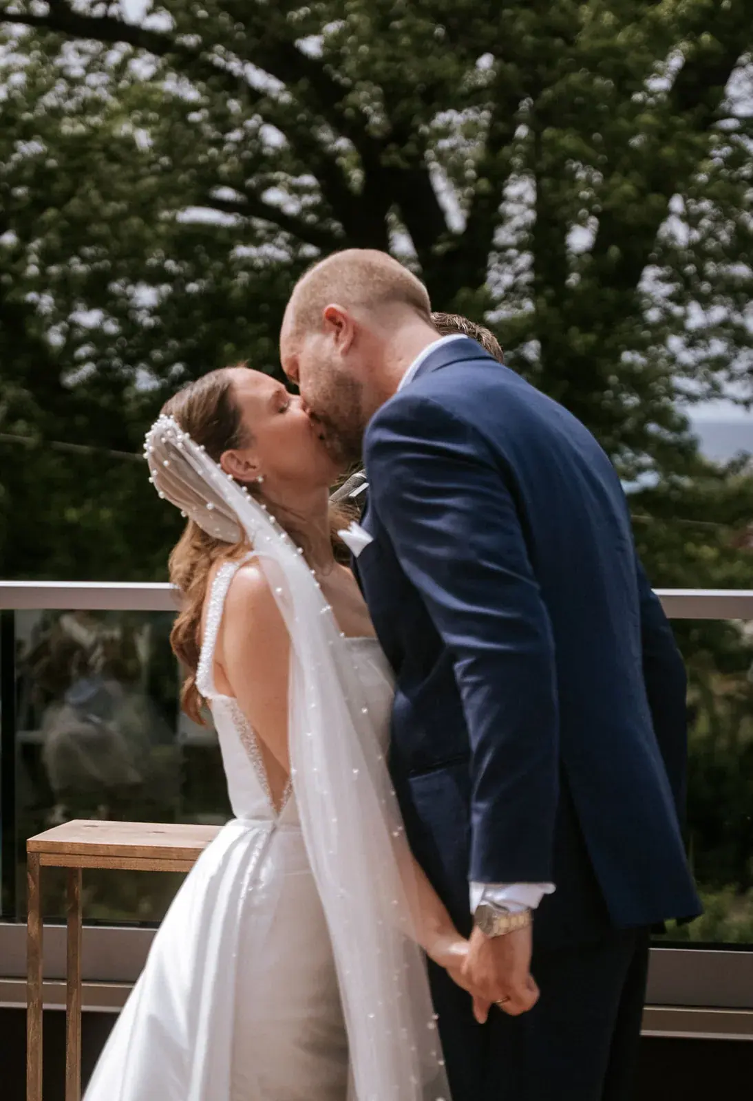 Bride and groom kiss terrace — Kelly & Ezra's wedding at Aria at The Whitcomb, St. Joseph