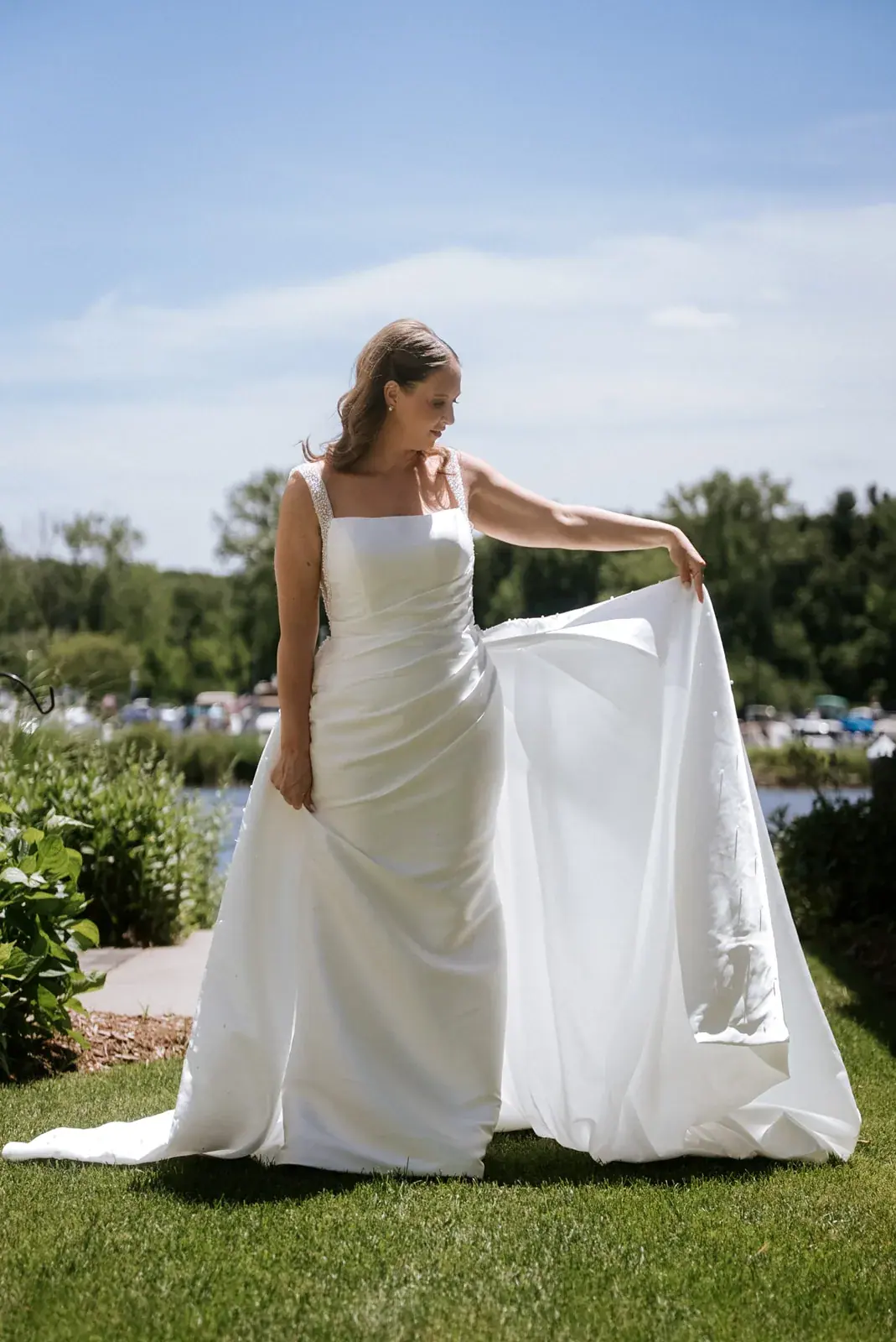 Bride portrait waterfront lawn — Kelly & Ezra's wedding at Aria at The Whitcomb, St. Joseph