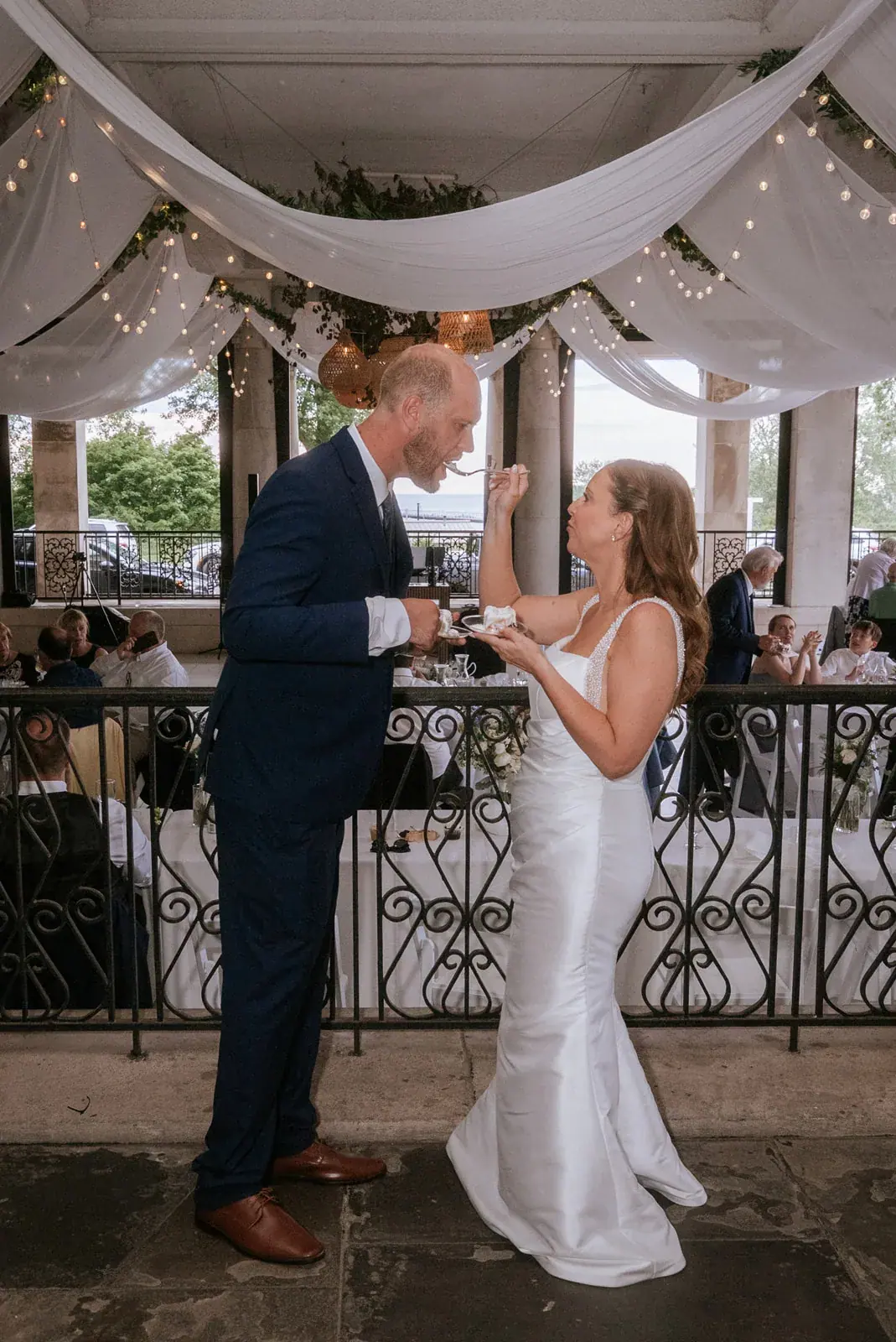 Bride and groom sharing a moment under a draped canopy at Aria at The Whitcomb