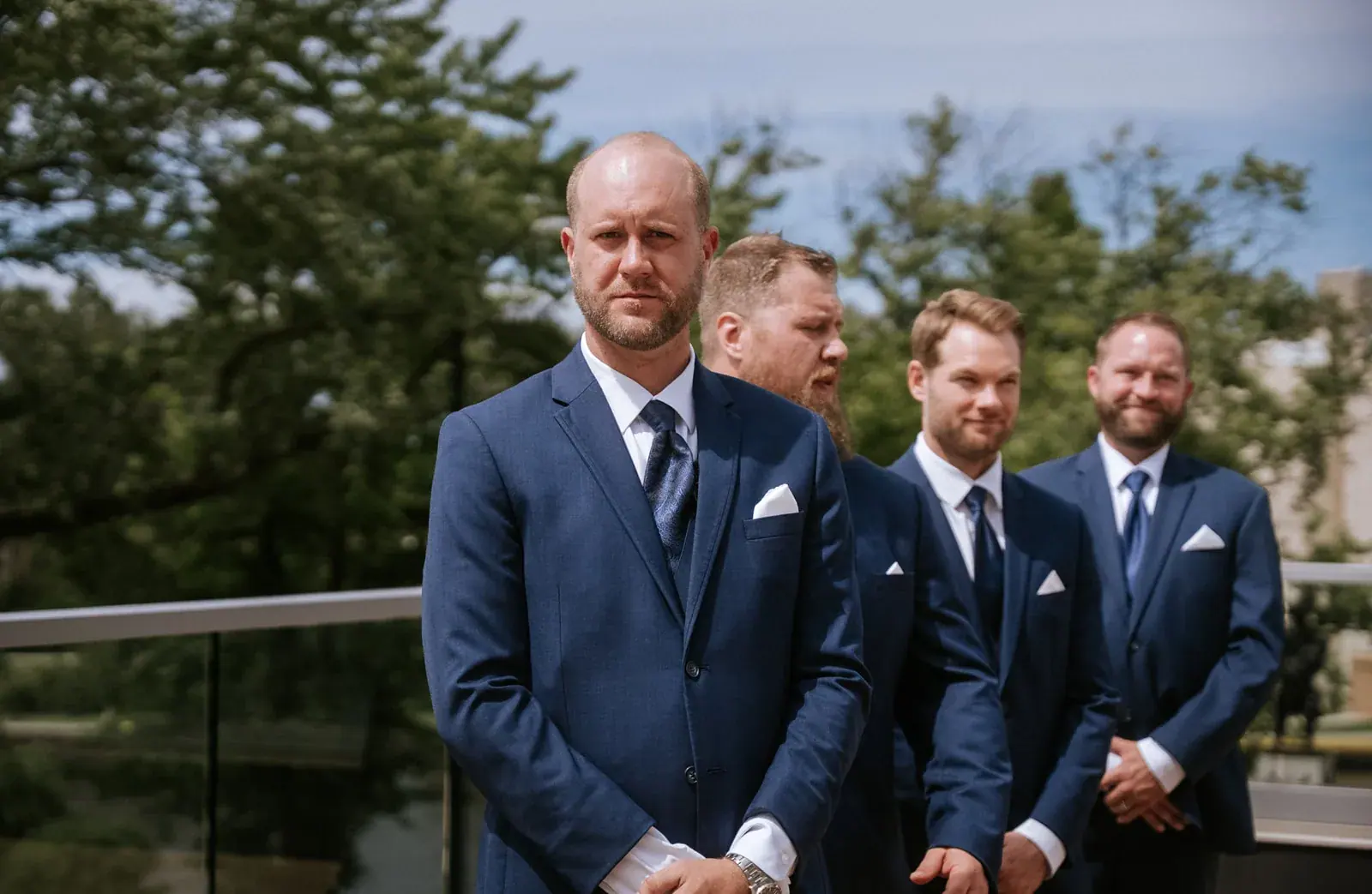 Groomsmen ceremony lake — Kelly & Ezra's wedding at Aria at The Whitcomb, St. Joseph