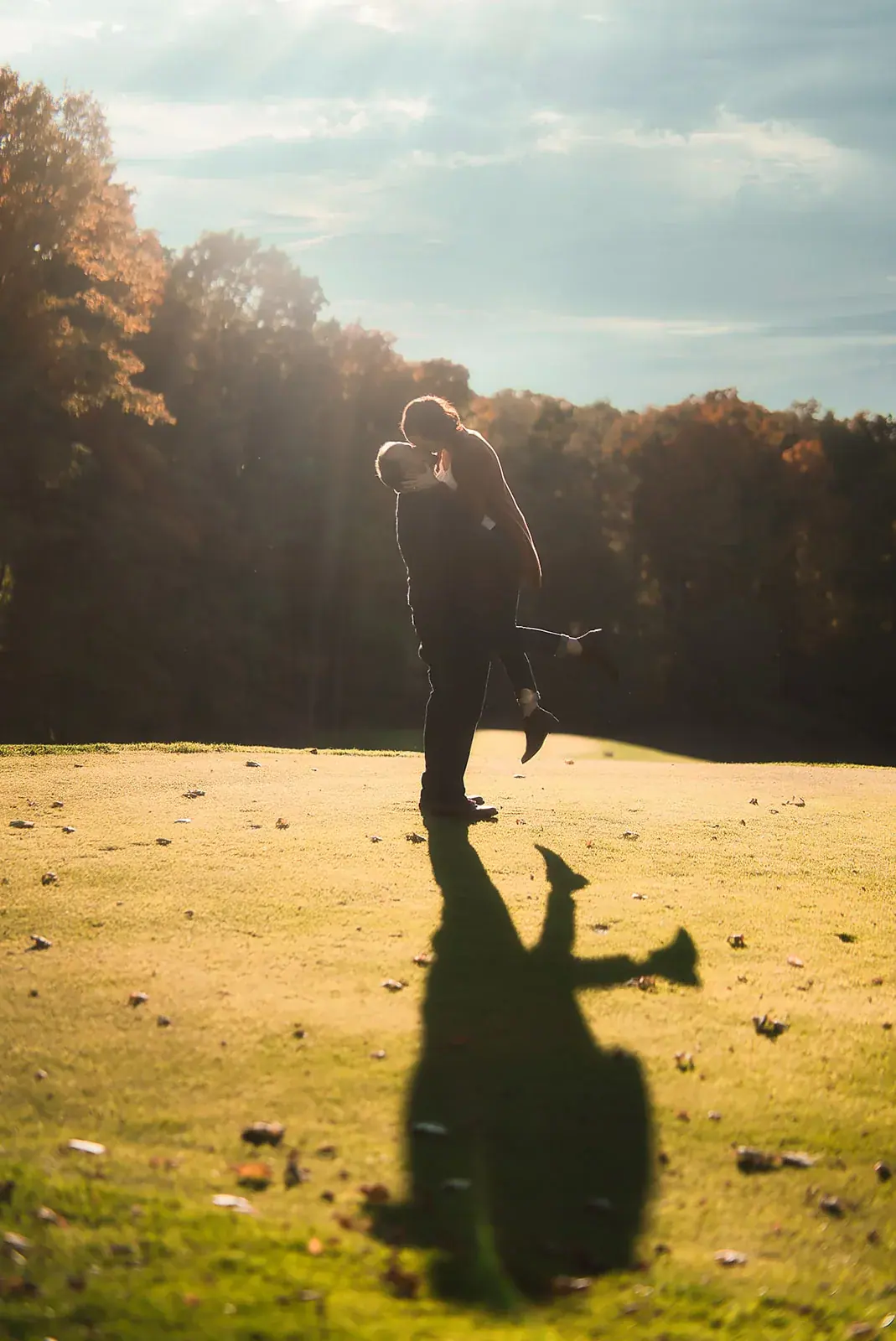 Lift kiss shadow golden hour — Matt & Adrian's engagement session at Boyne Mountain Resort