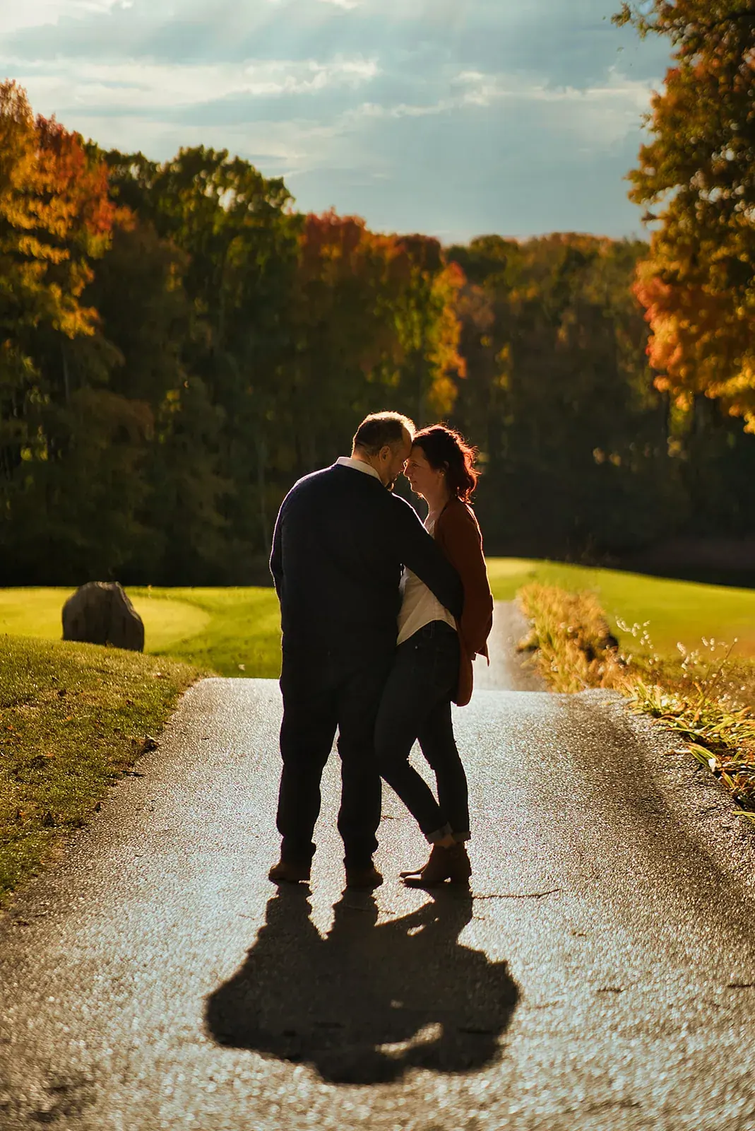 Silhouette embrace golf path — Matt & Adrian's engagement session at Boyne Mountain Resort