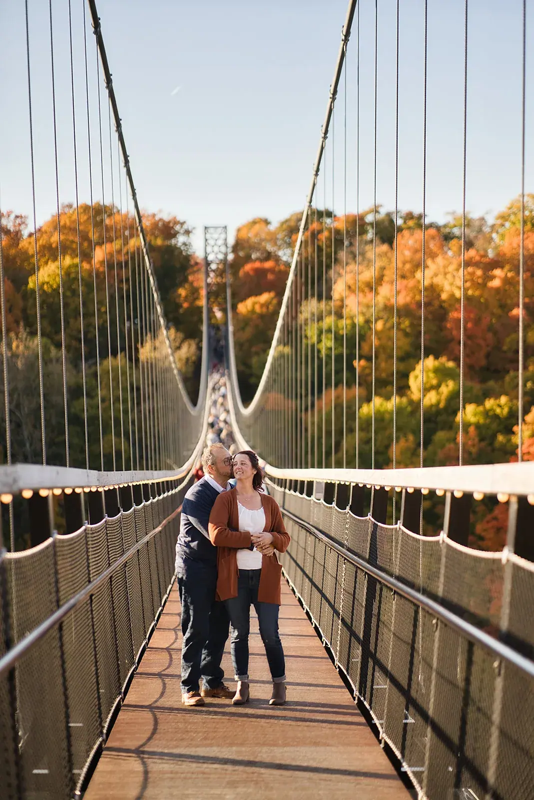 Skybridge walk fall colors — Matt & Adrian's engagement session at Boyne Mountain Resort
