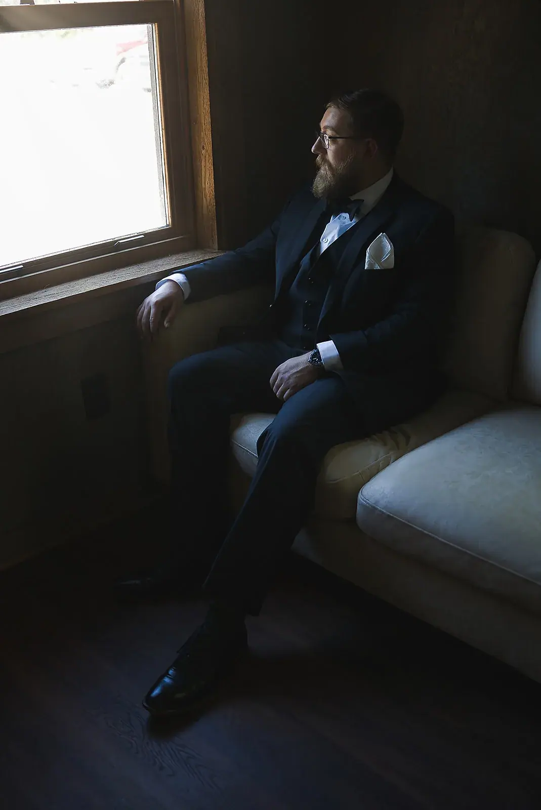 Groom waiting window — Megan & AJ's wedding at The Manor at Fire Tower Hill, Lewiston