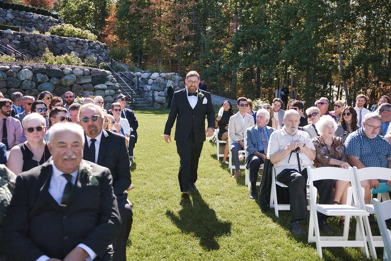 Groom walking aisle guests — Megan & AJ's wedding at The Manor at Fire Tower Hill, Lewiston