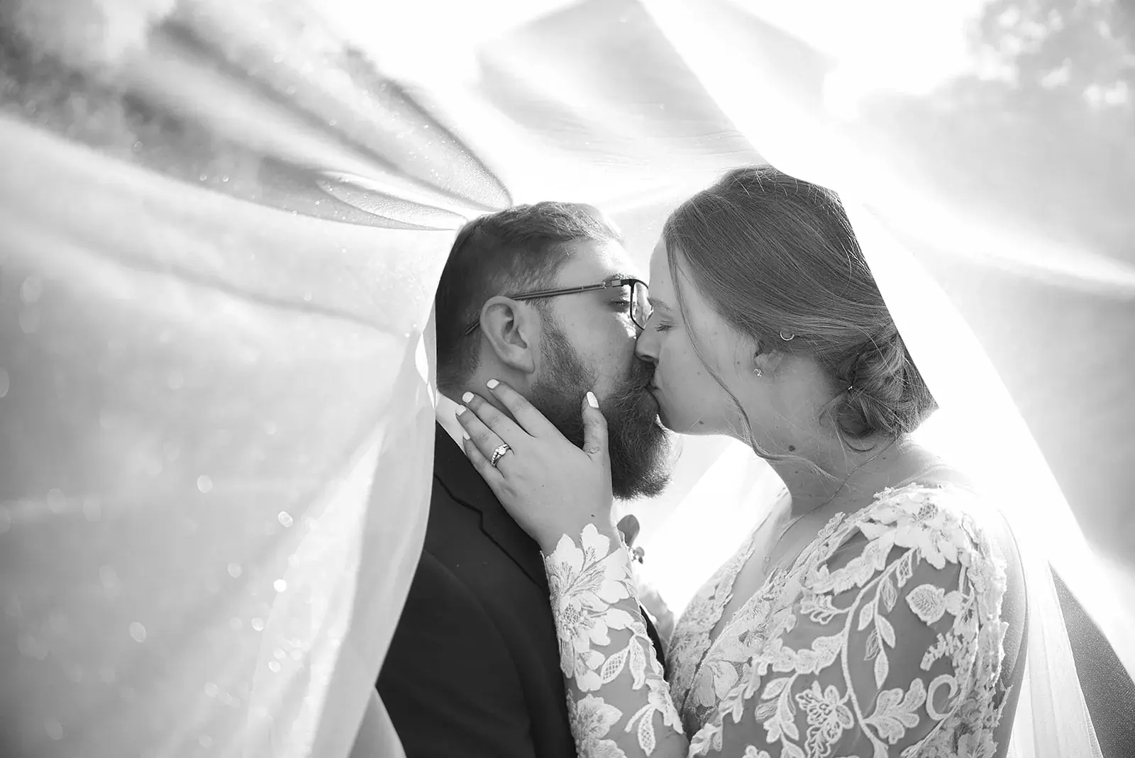 Under the veil kiss in black and white — Megan & AJ's wedding at The Manor at Fire Tower Hill, Lewiston