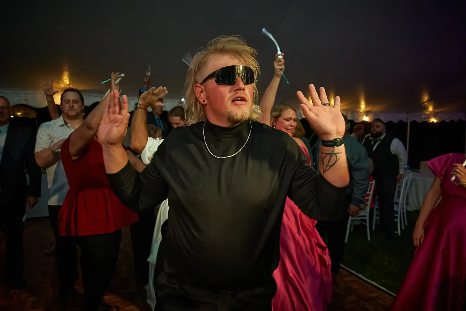Guest dancing in sunglasses at a Northern Michigan wedding reception